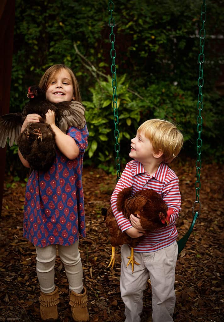 Adorable kids with hens