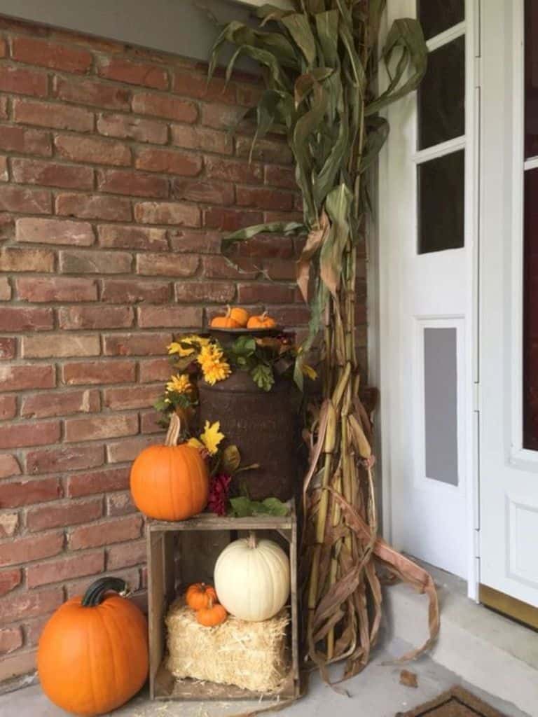 Front porch fall decorating with crates, corn stalks, pumpkins