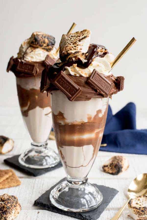 Chocolate smores extreme milkshake freakshake on grey background with blue napkin