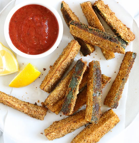 Breaded and baked zucchini sticks with garnish