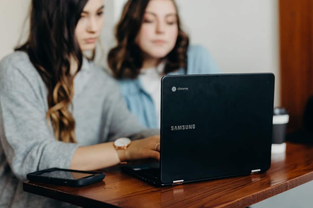 teen girls working on a computer